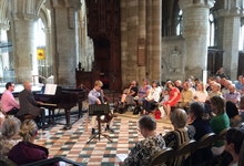 A cello recital taking place at the Nave Crossing